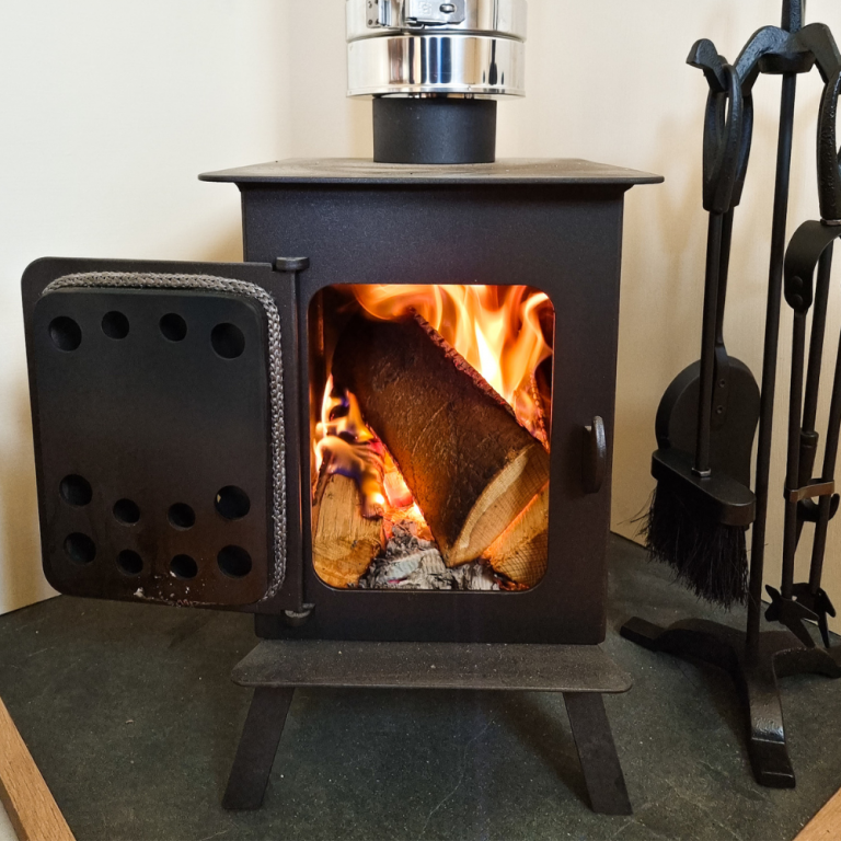 Classicshepherdhutwithroaringfireinsidewoodburner 768x768